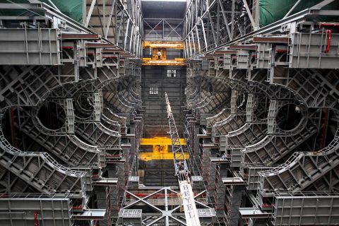 High up in the Vehicle Assembly Building at NASA's Kennedy Space Center in Florida, an overhead crane lowers the final work platform, A north, into place for installation in High Bay 3 on Jan. 12, 2017. (NASA/Frank Michaux)