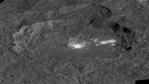 The bright areas of Occator Crater -- Cerealia Facula in the center and Vinalia Faculae to the side -- are examples of bright material found on crater floors on Ceres. This is a simulated perspective view. (NASA/JPL-Caltech/UCLA/MPS/DLR/IDA/PSI)