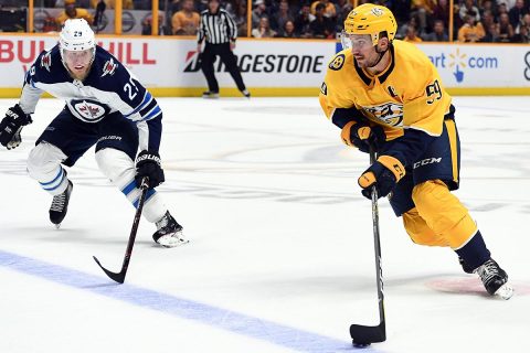 Nashville Predators defenseman Roman Josi (59) skates the puck into the offensive zone as he is defended by Winnipeg Jets right wing Patrik Laine (29) during the third period at Bridgestone Arena. (Christopher Hanewinckel-USA TODAY Sports)