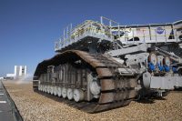 Crawler-transporter 2 (CT-2) moves slowly along the crawlerway on its way back to the Vehicle Assembly Building (in view in the background) at NASA’s Kennedy Space Center in Florida. (NASA/Leif Heimbold)