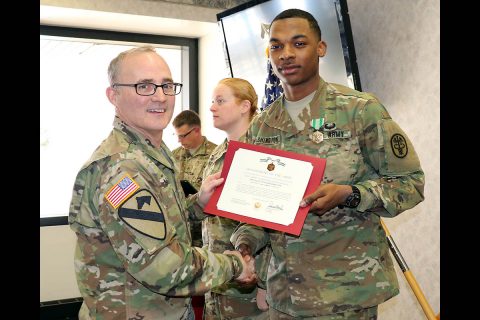 Blanchfield Army Community Hospital Commander, Col. Anthony L. McQueen, presents Spc. Ryan Washington the Army Commendation Medal during an award ceremony Jan. 19, for his selection as the hospital’s Soldier of the Year. Washington and fellow candidates competed in nine events including marksmanship, a physical fitness test, written exam with essay, selection board appearance, land navigation and battle drills. (U.S. Army, Maria Yager)