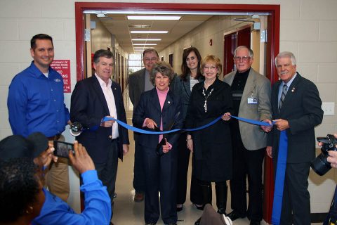 Clarksville Mayor Kim McMillan cuts a ribbon Wednesday to dedicate the new 17,000 square foot addition to the Ajax Turner Senior Citizens.