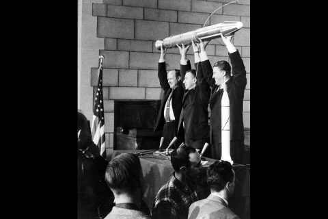 A model of Explorer 1 is held high by (left to right) JPL Director William Pickering, James Van Allen, and Wernher von Braun at a late-night news conference announcing the launch of Explorer 1, held at the National Academy of Sciences in Washington, DC. (NASA/JPL-Caltech)