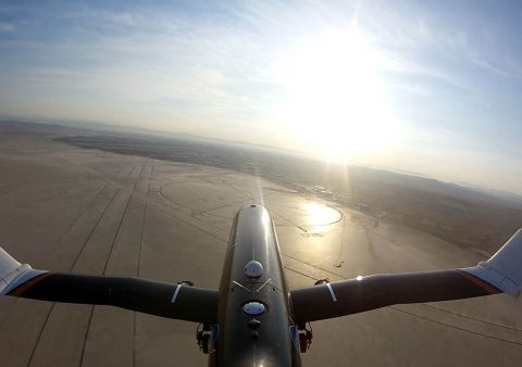 The subscale testbed PTERA flies over NASA Armstrong Flight Research Center in California with the outer portions of its wings folded 70 degrees upwards. The aircraft took off with its wings zero degrees deflection, keeping them level during takeoff. The wings were folded during the flight using a thermally-triggered shape memory alloy, developed at Glenn Research Center and integrated into an actuator at Boeing Research & Technology. (Area-I Inc.)