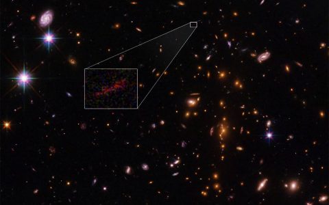 This Hubble Space Telescope image shows the farthest galaxy yet seen in an image that has been stretched and amplified by a phenomenon called gravitational lensing. (NASA , ESA, and B. Salmon (STScI))