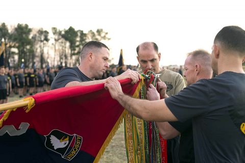 (L to R) Col. Joseph Escandon, 2nd Brigade Combat Team, 101st Airborne Division (Air Assault) commander, Maj. Gen. Andrew Poppas, 101st Abn. Div. commander, Command Sgt. Maj. Todd Sims, 101st Abn. Div. senior enlisted leader, and Command Sgt. Maj. Jason Wilson, 2nd BCT, 101st Abn. Div. senior enlisted leader, attach a streamer to the brigade’s guidon at Strike Field, Fort Campbell, Kentucky, Feb. 20, for the unit’s contribution to Operation Inherent Resolve during their most recent deployment to Iraq. (U.S. Army photo by Sgt. Samantha Stoffregen)