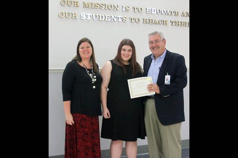 Rossview High Principal Dr. Schanda Banister Doughty and School Board member Charlie Patterson congratulate Kelsey Ann Burkhart.