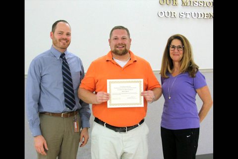 MCHS Assistant Principal Will Ferrell and School Board member Anne Murtha congratulate Scott Davis.