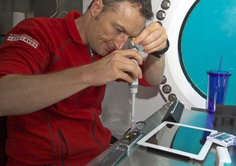 In this 2016 photo, Matthias Maurer of ESA inserts samples into the MinION DNA sequencer while at NASA's Extreme Environment Mission Operations (NEEMO), an underwater research facility. The MinION device will also be used as part of the Omics in Space project, which will develop new tools for studying microbiology in space. (NASA)