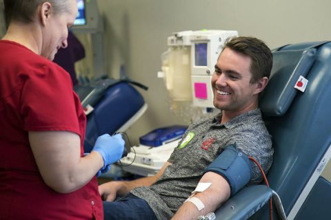 Zachary Sterbens gives a Power Red donation at the Red Cross Salt Lake City Blood Donation Center. He received a blood transfusion as a baby and has been donating for 5 years. (Amanda Romney/American Red Cross)