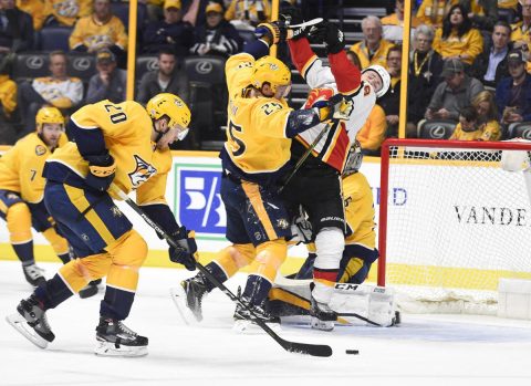 Nashville Predators defenseman Alexei Emelin (25) checks Calgary Flames left wing Matthew Tkachuk (19) in front of the Nashville Predators net during the second period at Bridgestone Arena. (Steve Roberts-USA TODAY Sports)