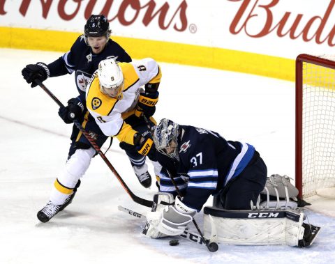 Winnipeg Jets goaltender Connor Hellebuyck (37) covers up the puck as defenseman Dmitry Kulikov (5) and Nashville Predators center Kyle Turris (8) try for a rebound at Bell MTS Place in the first period. (James Carey Lauder-USA TODAY Sports)