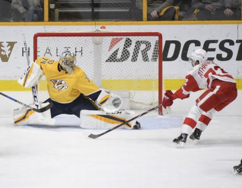 Nashville Predators goalie Juuse Saros (74) blocks the shot of Detroit Red Wings left wing Andreas Athanasiou (72) during the third period at Bridgestone Arena. (Steve Roberts-USA TODAY Sports) Nashville Predators goalie Juuse Saros (74) blocks the shot of Detroit Red Wings left wing Andreas Athanasiou (72) during the third period at Bridgestone Arena. (Steve Roberts-USA TODAY Sports)