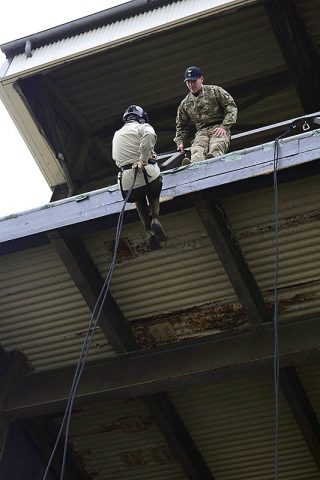 Under the watchful eye of Staff Sgt. Justin Spence, an instructor at The Sabalauski Air Assault School, Mary Boies, a member on the board of directors for Business Executives for National Security and counsel to Boies Schiller Flexner LLP, rappels down a 34-foot tower March 7th. (Sgt. Samantha Stoffregen, 101st Airborne Division (Air Assault) Public Affairs)