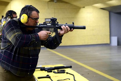 Micheal Tritt, a member of the Business Executives for National Security and president of Lane Power & Energy Solutions Inc., fires an MP5 suppressed submachine gun at Range 70, Fort Campbell, Kentucky, March 7, as part of an overall tour of the installation. (Sgt. Samantha Stoffregen, 101st Airborne Division (Air Assault) Public Affairs)