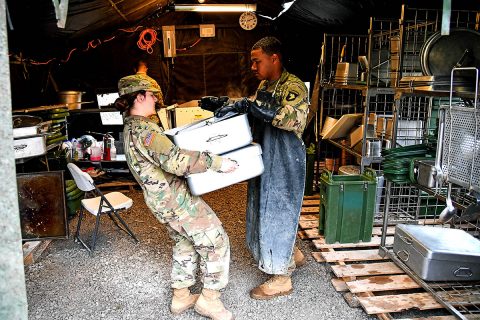 Pvt. Kaylee Jasper, a food service specialist with E. Company, 6th General Support Battalion, 101st Combat Aviation Brigade, 101st Airborne Division (Air Assault) delivers clean pans to the kitchen February 28, 2018, at Fort Campbell, Ky., during the 50th Annual Phil-lip A. Connelly Competition. "Just being here helped me learn a lot more than I ever could being in a dining facility," said Jasper. "This will definitely shape someone and if I re-enlist it will be because of Connelly." (Sgt. Marcus Floyd, 101st Combat Aviation Brigade) 