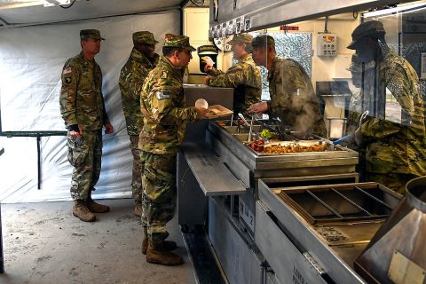 Soldiers from E. Company, 6th General Support Battalion, 101st Combat Aviation Brigade, 101st Airborne Division (Air Assault) serve food to the 101st CAB command team, Col. Craig Alia and Command Sgt. Maj. Reginald Thomas, February 28, 2018 at Fort Campbell, Ky., during the 50th Annual Phillip A. Connelly Competition. The Soldiers are competing at the Department of the Army level of the competition and representing Forces Command. (Sgt. Marcus Floyd, 101st Combat Aviation Brigade)