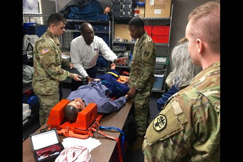 Nurse educator, Leroy Cantrell from Defense Medical Readiness Training Institute, Joint Base San Antonio, shows participants of the Trauma Nursing Core Course at Blanchfield Army Community Hospital how to use a pelvic sling. Cantrell traveled to Blanchfield March 5 to 9, to teach the TNCC and evaluate the hospital's TNCC program. (U.S. Army photo by Maria Yager)