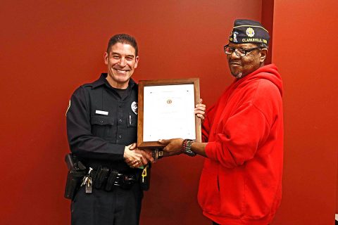 American Legion Fort Campbell Post 289 presents Clarksville Police Officer Coz Minetos with the Law Enforcement Officer of the Year plaque.