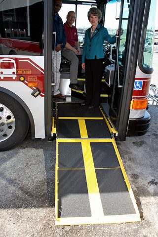 Clarksville Mayor Kim McMillan on one of the new Clarksville Transit System fuel-efficient hybrid buses.