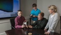 Engineers from NASA Marshall Space Flight Center’s Propulsion Department examine nozzles fabricated using a freeform-directed energy wire deposition process. From left are Paul Gradl, Will Brandsmeier, Ian Johnston and Sandy Greene, with the nozzles, which were built using a NASA-patented technology that has the potential to reduce build time from several months to several weeks. (NASA/MSFC/Emmett Given)