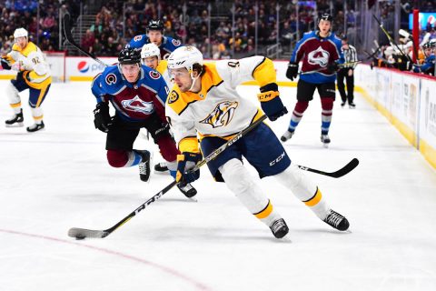 Colorado Avalanche defenseman Tyson Barrie (4) chases down Nashville Predators left wing Filip Forsberg (9) in the first period at the Pepsi Center. (Ron Chenoy-USA TODAY Sports)