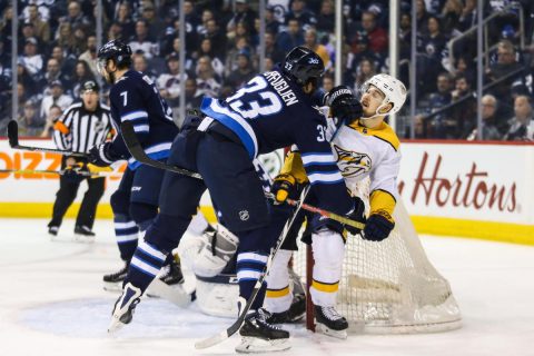 Winnipeg Jets defenseman Dustin Byfuglien (33) checks Nashville Predators forward Viktor Arvidsson (38) during the first period at Bell MTS Place. (Terrence Lee-USA TODAY Sports)