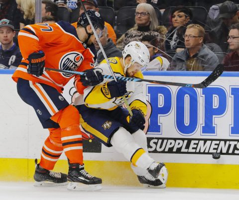 Edmonton Oilers defensemen Oscar Klefbom (77) and Nashville Predators forward Viktor Arvidsson (33) battle for a loose puck during the second period at Rogers Place. (Perry Nelson-USA TODAY Sports)