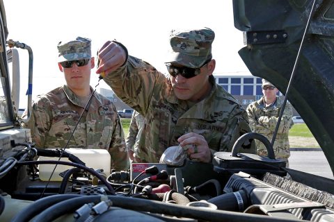 Sgt. Justin Caton, and Sgt. Robert Keys, instructors at The Sabalauski Air Assault School, 101st Airborne Division (Air Assault), perform preventative maintenance checks and services on a high mobility multipurpose wheeled vehicle during the Headquarters and Headquarters Battalion Driver’s Training Course test, March 23, 2018, Fort Campbell, Ky. (Pfc. Beverly Roxane Mejia, 40th Public Affairs Detachment)