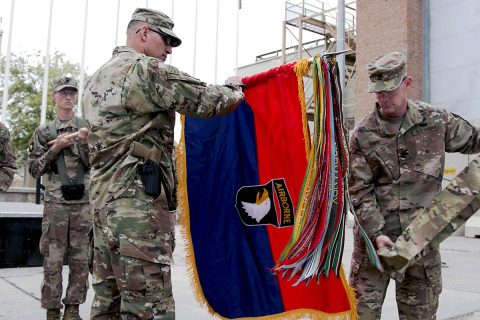 Maj. Gen. Andrew Poppas, 101st Airborne Division (Air Assault) commander, and Command Sgt. Maj. Todd Sims, 101st Abn. Div. senior enlisted leader, unfurl the division headquarters' colors, April 15, during a transfer of authority ceremony at Bagram Airfield, Afghanistan. (Staff Sgt. Lerone Simmons, U.S. Forces Afghanistan)