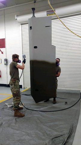 Pfc. Daniel Watts, a Soldier with B. Company, 96th Aviation Support Battalion, 101st Combat Aviation Brigade irons the fabric of a damaged glider wing November 7, 2017 at Fort Campbell, Ky. During the Don F. Pratt Museum renovation, a unit mascot damaged the wing of a World War II era-glider and a team of seven Soldiers from the 101st CAB repaired the wing. (Staff Sgt. Ian Thompson, 101st Combat Aviation Brigade) 