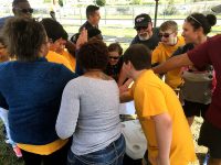 Volunteers from Blanchfield Army Community Hospital and students and staff from Northeast Middle School give a cheer a before heading to their first events at the Special Olympics of Greater Clarksville Spring Games, April 13. (U.S. Army photo by Maria Yager)