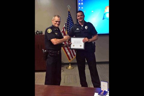 Clarksville Police Chief Al Ansley presents Officer Timothy Simulis with a Lifesaver Award. (CPD)