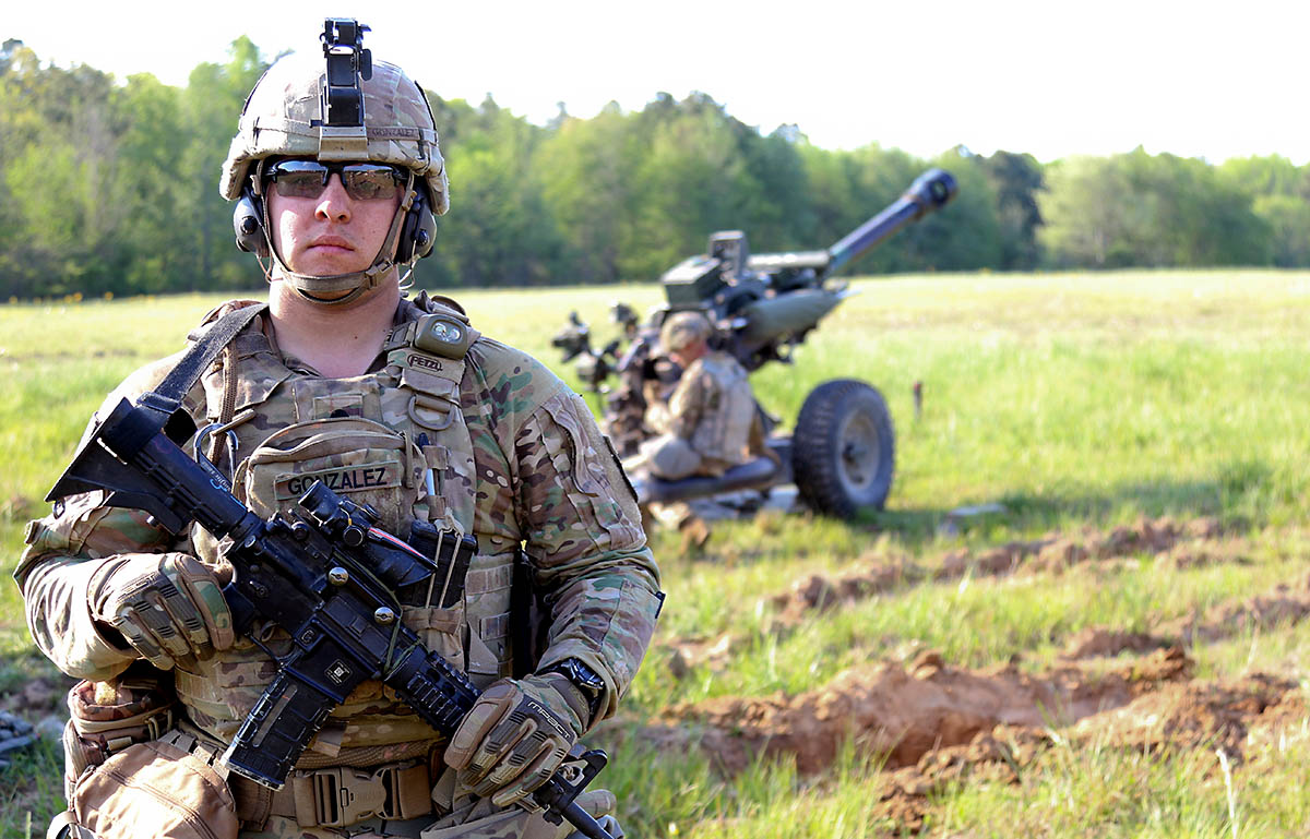 Spc. Anthony Gonzalez, a Combat Medic Specialist and a Fontana, California, native, with 2nd platoon, Headquarters and Headquarters Battalion, 3rd Battalion, 320th Field Artillery Regiment, 101st Airborne Division Artillery Brigade, poses for a photo during the unit’s Table XV gunnery exercise 9th May at Fort Campbell, Kentucky. (Sgt. Sharifa Newton, 40th Public Affairs Detachment)