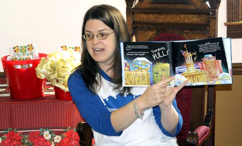 Carrie Lanier, Junior Auxiliary of Clarksville life member, reads a story during a Christmas event for underprivileged children. Junior Auxiliary invites Clarksville-Montgomery County ladies to learn more about the nonprofit organization during an Open House, May 19th.