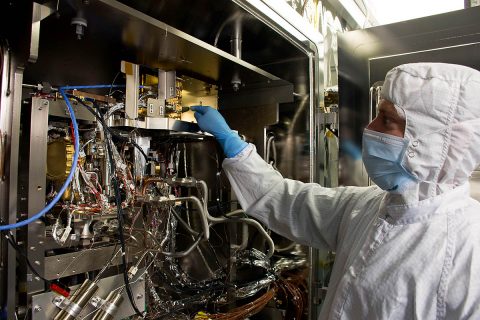 Precision assembly and mechanical technician Ryan Wilkinson inspects MOMA during thermal vacuum testing at Goddard. (NASA)