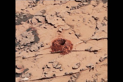 A close-up image of a 2-inch-deep hole produced using a new drilling technique for NASA's Curiosity rover. The hole is about 0.6 inches across (1.6 centimeters). This image was taken by Curiosity's Mast Camera (Mastcam) on Sol 2057. It has been white balanced and contrast-enhanced. (NASA/JPL-Caltech/MSSS)