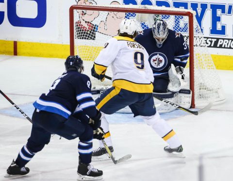 Nashville Predators left wing Filip Forsberg (9) scores a goal against Winnipeg Jets goaltender Connor Hellebuyck (37) in the third period in game six of the second round of the 2018 Stanley Cup Playoffs at Bell MTS Centre. (Terrence Lee-USA TODAY Sports)