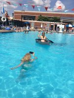 Signal Mountain Middle/High School’s Lili Swann captures a photo of Merrol Hyde Magnet School’s Gracie Gumm paddling the duct tape boat at APSU’s recreational pool.