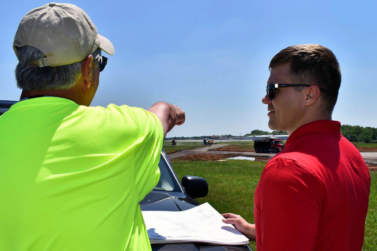 Project Manager Rick Hudgens, PDC Consultants, LLC, briefs Assistant Airport Manager Nick Blalock on the runway improvements underway at Clarksville Regional Airport. These improvements include resurfacing and upgrading the primary runway and its markings, lighting and signage, as well as increasing existing taxiway clearances.
