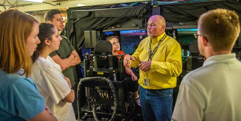 John Kokoski, flight instructor at the Transportable Blackhawk Operations Simulator explains how the TBOS for an UH-60M Black Hawk Multi-Mission Helicopter functions. The TBOS’s purpose is to give Army pilots a real time, real feel flying hours and practice their piloting skills before actually taking flight. (Sgt. Steven Lopez, 40th Public Affairs Detachment)