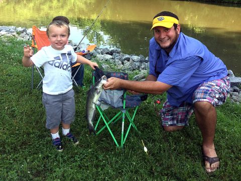 This boy and father celebrate catching a fish during the Cheatham Lake Annual Fishing Rodeo in Ashland City, Tennessee, June 16th, 2018. (Trey Church, USACE)