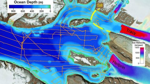 This figure shows estimated ice flow velocities of Tracy and Heilprin glaciers (right) and the depths of the fjord in front of the glaciers. The approximate location of the sill in front of Tracy is shown as a dashed yellow line. Research ship cruise tracks are shown in orange. (NASA/JPL-Caltech)