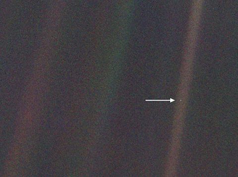 This image, taken by NASA's Voyager 1 spacecraft from beyond the orbit of Neptune, shows planet Earth as seen from about 3.7 billion miles (5.9 billion km) away. Earth appears as a very small point of light in the right half of the image, indicated by an arrow. Dubbed the "Pale Blue Dot," the image illustrates just how small an Earth-sized planet appears from far away. (NASA/JPL-Caltech)