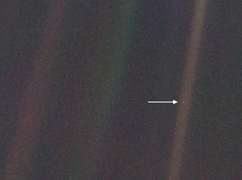 This image, taken by NASA's Voyager 1 spacecraft from beyond the orbit of Neptune, shows planet Earth as seen from about 3.7 billion miles (5.9 billion km) away. Earth appears as a very small point of light in the right half of the image, indicated by an arrow. Dubbed the "Pale Blue Dot," the image illustrates just how small an Earth-sized planet appears from far away. (NASA/JPL-Caltech)