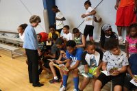 Clarksville Mayor Kim McMillan listens as children describe the books they received at the kick-off event for Read20 Book Patrol at the Burt-Cobb Community Center July 9, 2018. Read20 Book Patrol is a program that is encouraging young children to read at least 20 minutes a day, while partnering with law enforcement to build positive relationships with officers in Tennessee communities.