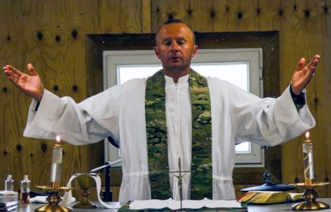 Chaplain (Cpt) Marcin Bulinski, assigned to the 101st Special Troops Battalion, 101st Airborne Division (Air Assault) Resolute Support Sustainment Brigade, performs a Requiem Mass at Camp Morehead, Afghanistan. (U.S Army Photo by Spc. Alexes Anderson)