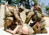 Sgt. First Class Frank Muramoto, 101st Airborne Division (Air Assault) Resolute Support Sustainment Brigade medical operations non-commissioned officer in charge, observes while PFC Keith Brown, and PFC Quesada-Hernandez, perform combat lifesaver techniques to a casualty dummy, on Bagram Airfield, Afghanistan, July 26.  (1st Lt. Verniccia Ford, 101st Airborne Division (AA) Sustainment Brigade Public Affairs)