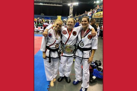 Austin Peay State University senior Allie Honeycutt, center, wears her gold belt with her teammates last month at the Tae Kwon-Do International World Championships in Birmingham, England.