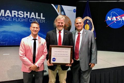 Austin Peay State University representatives Dr. Donald Sudbrink, center, professor and chair of the APSU Department of Agriculture; Bill Persinger, right, executive director for Public Relations & Marketing; and Bryan Gaither, lab manager for the Department of Physics, Engineering and Astronomy, accepted the award with other members of the Marshall Space Flight Center Solar Eclipse Team on August 22nd in Huntsville, AL.